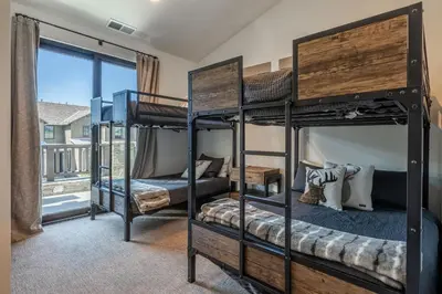a bedroom with three bunk beds and a window at Creekhouse 1342 in Mammoth Lakes