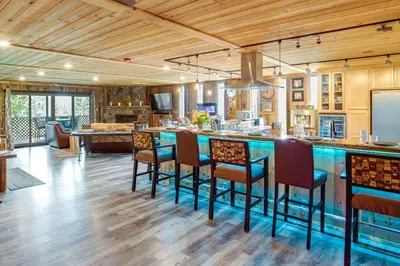 an open kitchen with a bar with stools at Game Room, Mtn Views! Unit 1 Mi to Heavenly Resort in Stateline