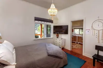 a bedroom with a large bed and a television at The Haven -In Town, NEWLY remodeled, Private, Stocked in Mariposa