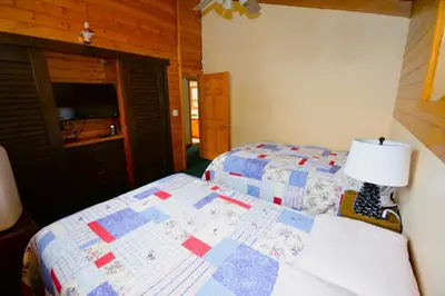 a bedroom with a bed with a quilt on it at Johnson Lake FrontReduced Nightly Rates in Bass Lake