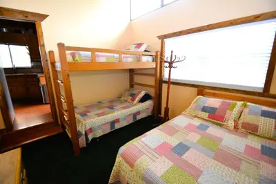 a bedroom with two bunk beds and a window at Johnson Lake FrontReduced Nightly Rates in Bass Lake