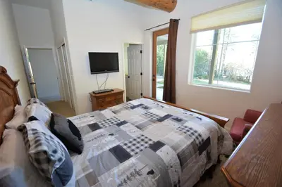 a bedroom with a bed and a tv and a window at Lake Shore Lake Front Free Night Special in Bass Lake