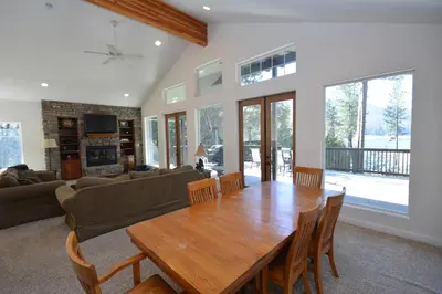 a living room with a wooden table and a couch at Lake Shore Lake Front Free Night Special in Bass Lake