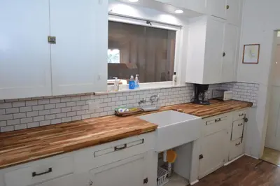 a kitchen with white cabinets and a sink and a window at Dupzyk Lake Front Reduced Nightly Rate in Bass Lake