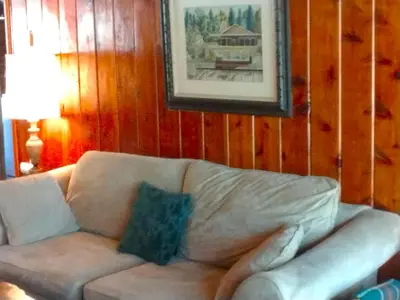 a couch in a living room with a picture on the wall at Idylwild-Lake Area in Bass Lake