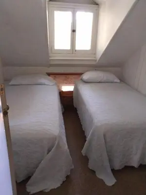 two beds in a room with a window at Idylwild-Lake Area in Bass Lake