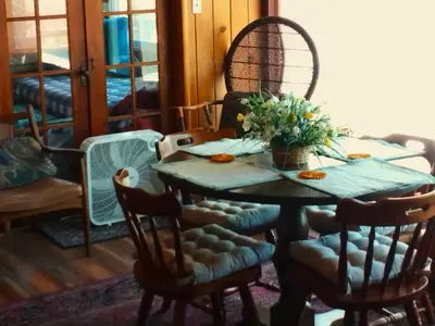 a dining room with a table and chairs with flowers on it at Idylwild-Lake Area in Bass Lake