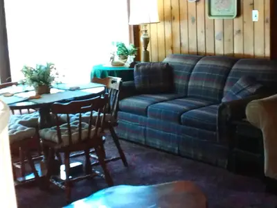 a living room with a couch and a table at Idylwild-Lake Area in Bass Lake