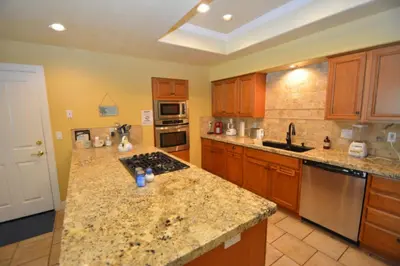a large kitchen with wooden cabinets and granite counter tops at King- Lake Area in Bass Lake