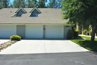 a house with two garage doors in a driveway at King- Lake Area in Bass Lake