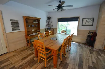 a dining room with a wooden table and chairs at Walter- Lake AreaFree Night Special in Bass Lake