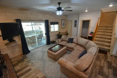a living room with a couch and a television at Walter- Lake AreaFree Night Special in Bass Lake