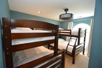 a bedroom with two bunk beds and a window at Walter- Lake AreaFree Night Special in Bass Lake