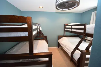 two bunk beds in a room with blue walls at Walter- Lake AreaFree Night Special in Bass Lake