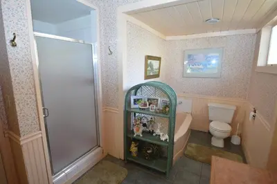 a small bathroom with a shower and a toilet at O'Connell-Lake Area Free Night Special in Bass Lake