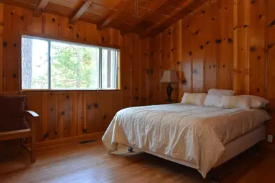a bedroom with a bed in a room with a window at O'Hara Lake View in Bass Lake