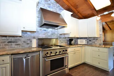 a kitchen with white cabinets and a stove top oven at O'Hara Lake View in Bass Lake