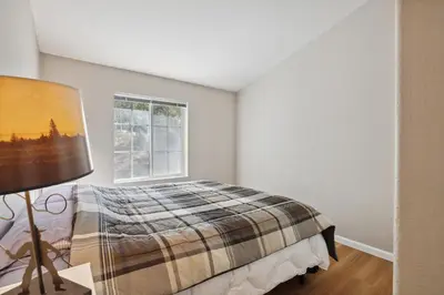 a bedroom with a bed and a window at Newly Renovated Retreat on 6 Acres, Discover Murphys Lodge with Scenic Views! in Murphys