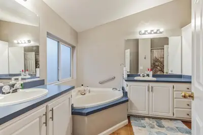 a bathroom with two sinks and a large mirror at Newly Renovated Retreat on 6 Acres, Discover Murphys Lodge with Scenic Views! in Murphys