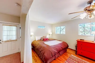 a bedroom with a bed and a red dresser at The Lake Haus in Groveland