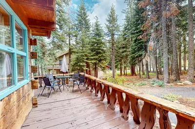 a wooden deck with a table and chairs on it at Pine Knolls in Tahoma