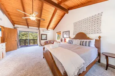 a bedroom with a bed and a ceiling fan at Yosemite Cowboy Cabin in Oakhurst