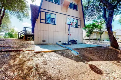 a house with a basketball hoop in front of it at Cozy Cabin in Groveland