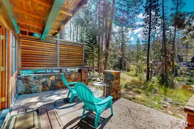 a patio with two chairs and a table on a house at Sierra Secret in Soda Springs