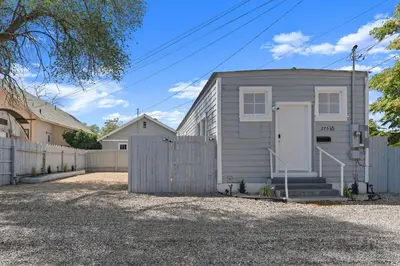 a gray house with a fence in a driveway at Tranquil Retreat: Cozy 2Bed, 1Bath Oasis in Fallon in Fallon
