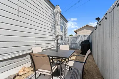 a patio with a table and chairs next to a fence at Tranquil Retreat: Cozy 2Bed, 1Bath Oasis in Fallon in Fallon