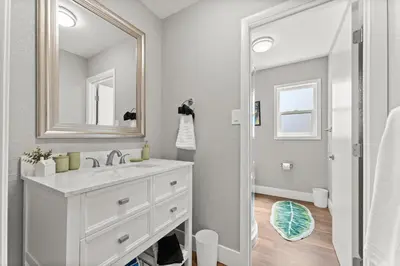 a white bathroom with a sink and a mirror at Tranquil Retreat: Cozy 2Bed, 1Bath Oasis in Fallon in Fallon