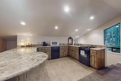 a large kitchen with wooden cabinets and a counter top at Tranquil Pines Estate in Shaver Lake