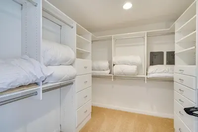 a walk in closet with white closets at Discovery Bay Home with On-Site Delta Access! in Discovery Bay