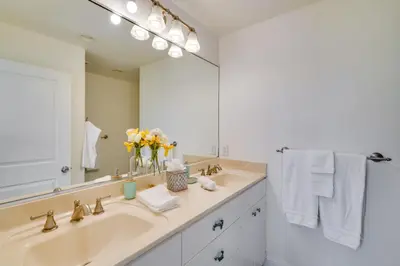 a bathroom with a sink and a large mirror at Discovery Bay Home with On-Site Delta Access! in Discovery Bay
