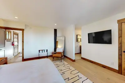 a bedroom with a bed and a tv on a wall at Pine Haven Retreat in Stateline