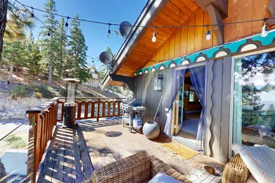 a house with a wooden deck with a patio at Pine Haven Retreat in Stateline
