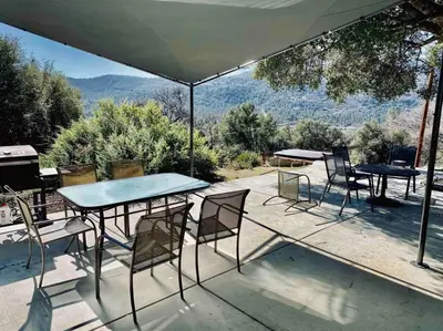 a table and chairs sitting on a patio with a view at Black Bear Suite Hot Tub Sleeps 4 affordable in Oakhurst