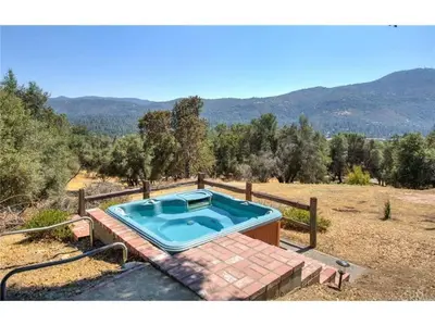 a swimming pool in the middle of a field at Black Bear Suite Hot Tub Sleeps 4 affordable in Oakhurst