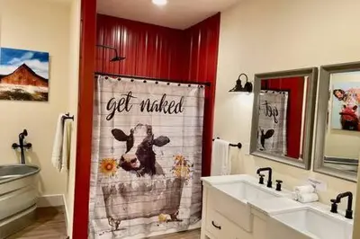 a bathroom with a cow shower curtain and a sink at Crazy Cow Private HOT TUB BBQ Sleeps 2 in Ahwahnee