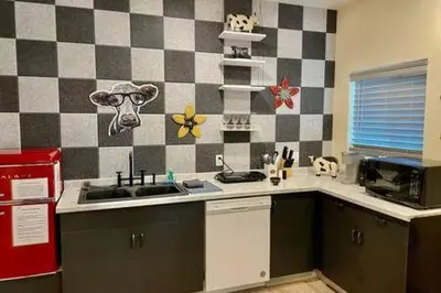 a kitchen with a cow head on the wall at Crazy Cow Private HOT TUB BBQ Sleeps 2 in Ahwahnee