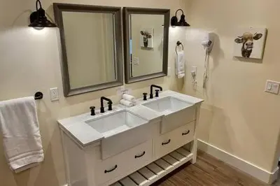 a white bathroom with a sink and a shower at Crazy Cow Private HOT TUB BBQ Sleeps 2 in Ahwahnee