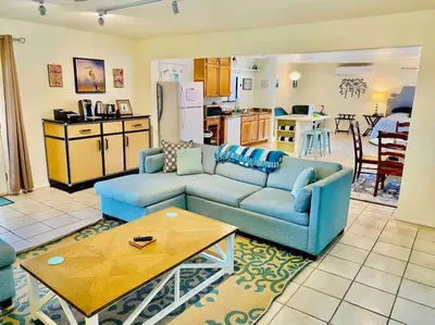 a living room with two blue couches and a kitchen at Crane Suite Hot Tub Bbq King Bed- Sleeps 4 in Ahwahnee
