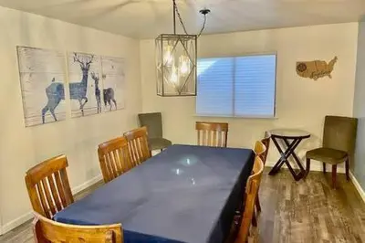 a dining room with a blue table and chairs at Deer Haven Hot Tub Foosball Pool Table in Ahwahnee