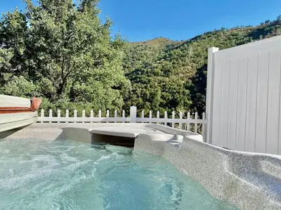 a plunge pool with a bench next to a fence at Eagle Nest River Views Hot Tub Games Sleeps 6 in Ahwahnee