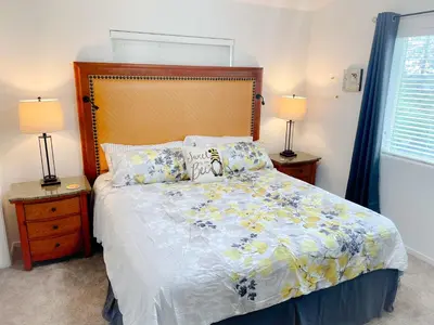 a bedroom with a bed and two lamps and a window at Honeybee Hive HOT TUB BBQ 8 minutes to Bass Lake Sleeps up to 6 in North Fork