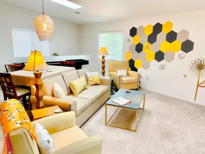 a living room with a couch and chairs and a piano at Honeybee Hive HOT TUB BBQ 8 minutes to Bass Lake Sleeps up to 6 in North Fork