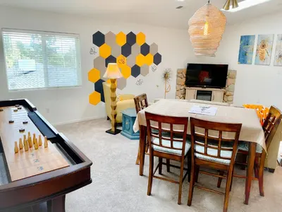 a living room with a dining room table and a game room at Honeybee Hive HOT TUB BBQ 8 minutes to Bass Lake Sleeps up to 6 in North Fork