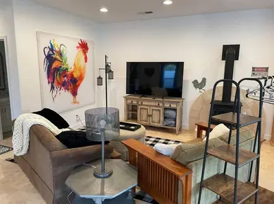 a living room with a couch and a tv at The Funky Chicken Hot Tub BBQ SLEEPS 4 in Ahwahnee