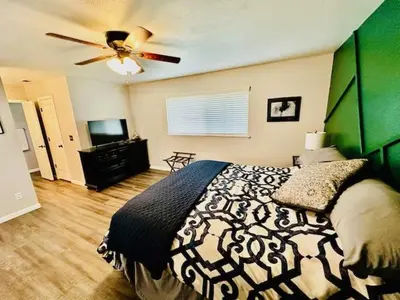 a bedroom with a bed and a ceiling fan at The Lighthouse Pet Friendly Hot Tub BBQ Sleeps 11 in Coarsegold