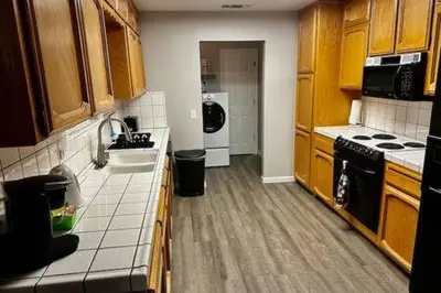 a kitchen with a sink and a stove at The Lighthouse Pet Friendly Hot Tub BBQ Sleeps 11 in Coarsegold
